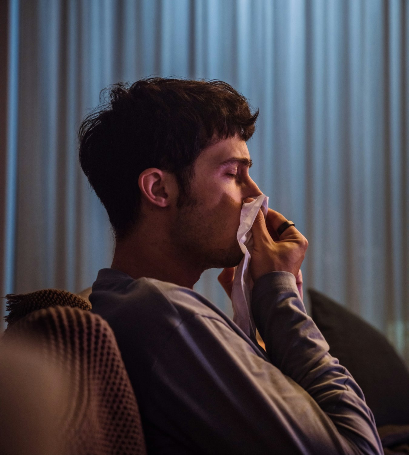 Man reaches for a tissue while wearing his Oura ring